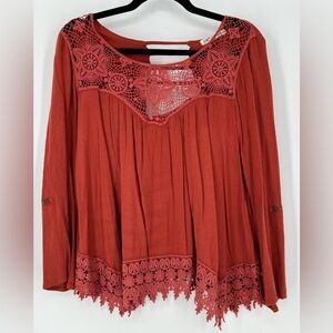 JOLT bohemian-style top w/intricate crochet lace detailing & flowy silhouette.